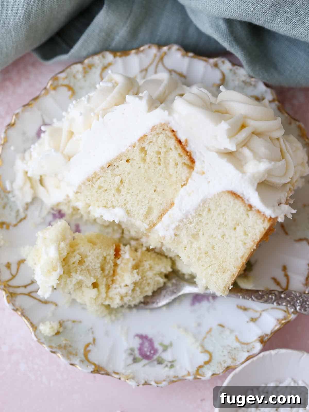 Velvet Vanilla Cake Recipe 28 A delicate slice of moist vanilla cake elegantly presented on a vintage purple plate.
