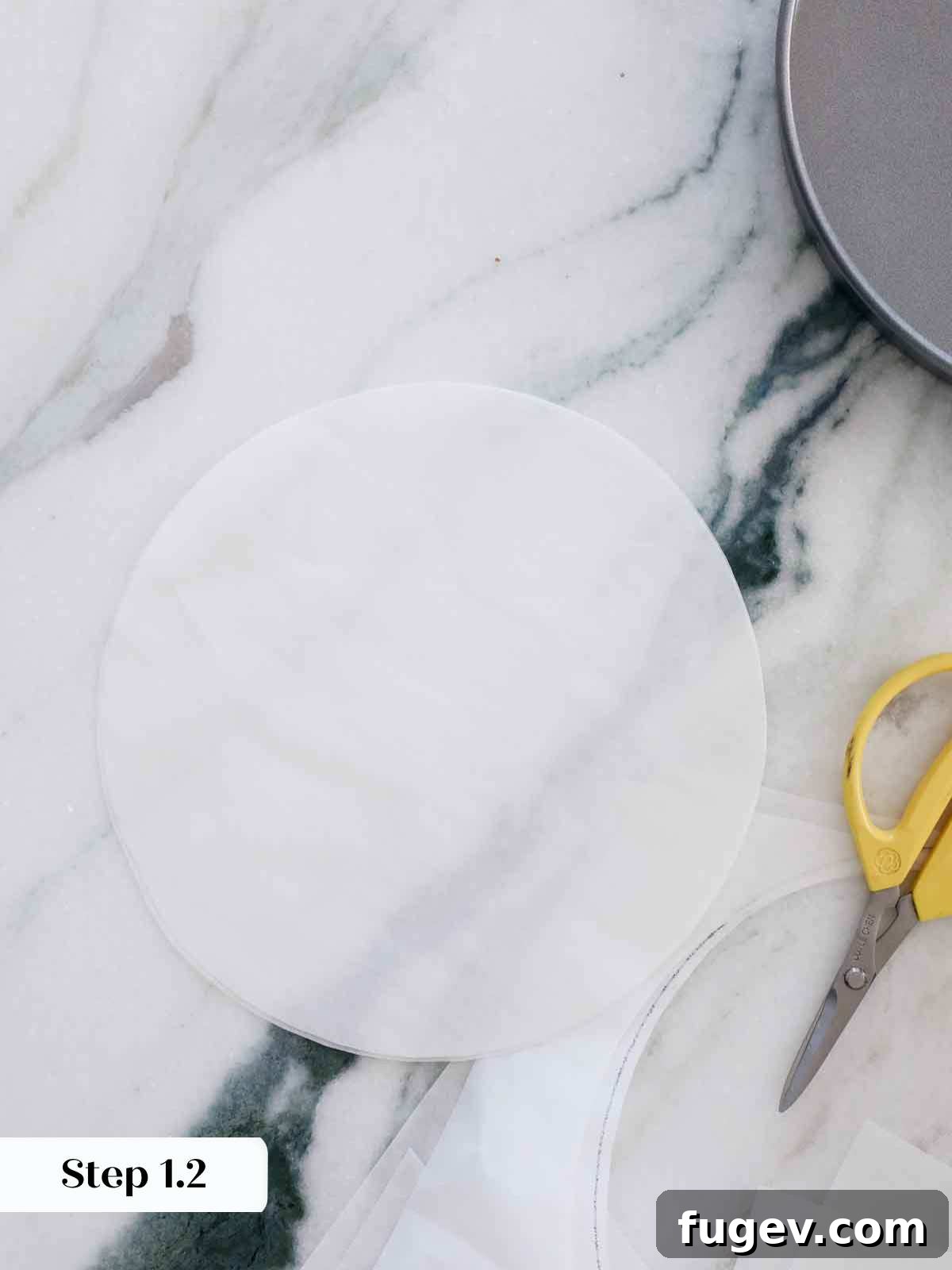 Velvet Vanilla Cake Recipe 9 Cutting out parchment paper circles to precisely line cake pans.