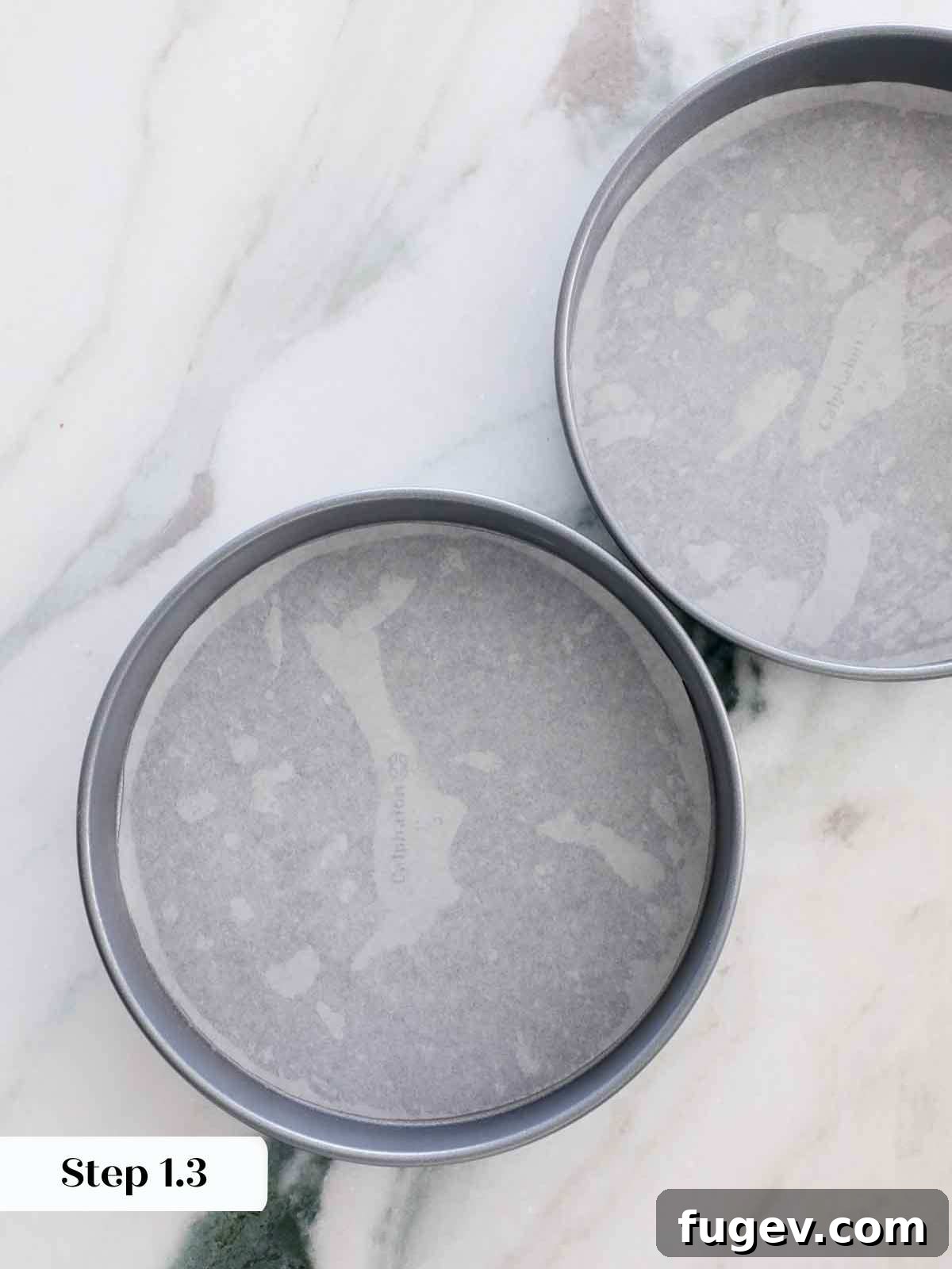 Velvet Vanilla Cake Recipe 10 Two cake pans meticulously lined with parchment paper, ready for batter.