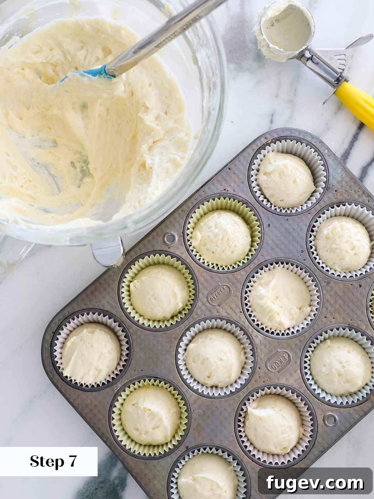 Zesty Lemon Delights 12 portioning lemon cupcake batter into liners.