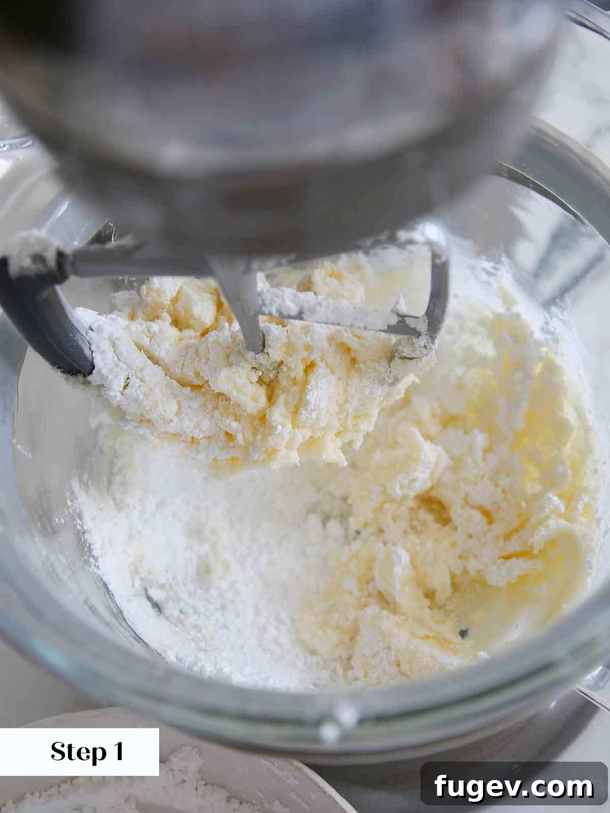 Zesty Lemon Delights 15 adding sugar to butter in lemon buttercream frosting.