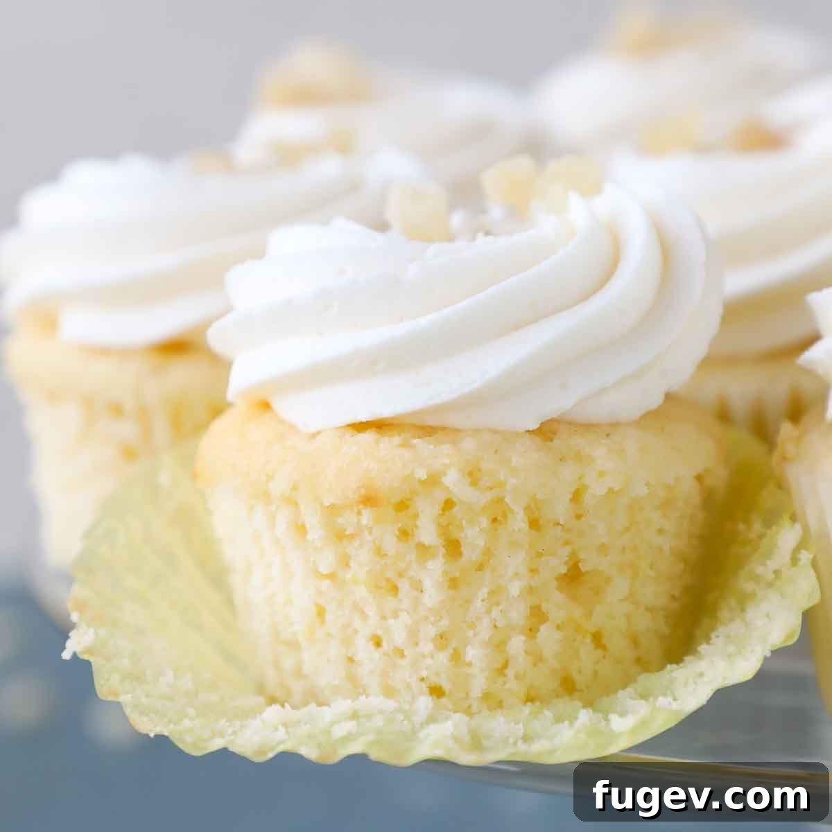 Zesty Lemon Delights 17 unwrapped lemon cupcakes with yellow liner.