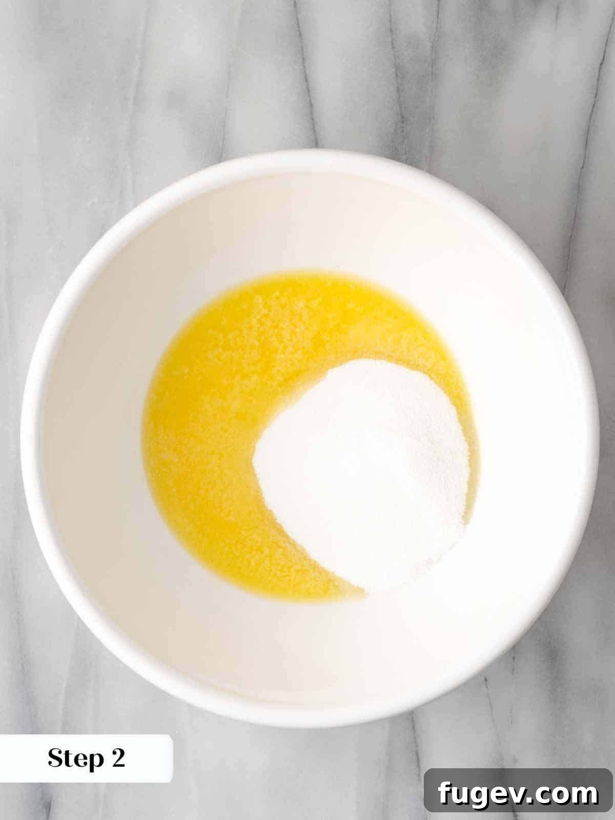 Sweet Cornbread Perfection 5 melted butter and sugar in white bowl.