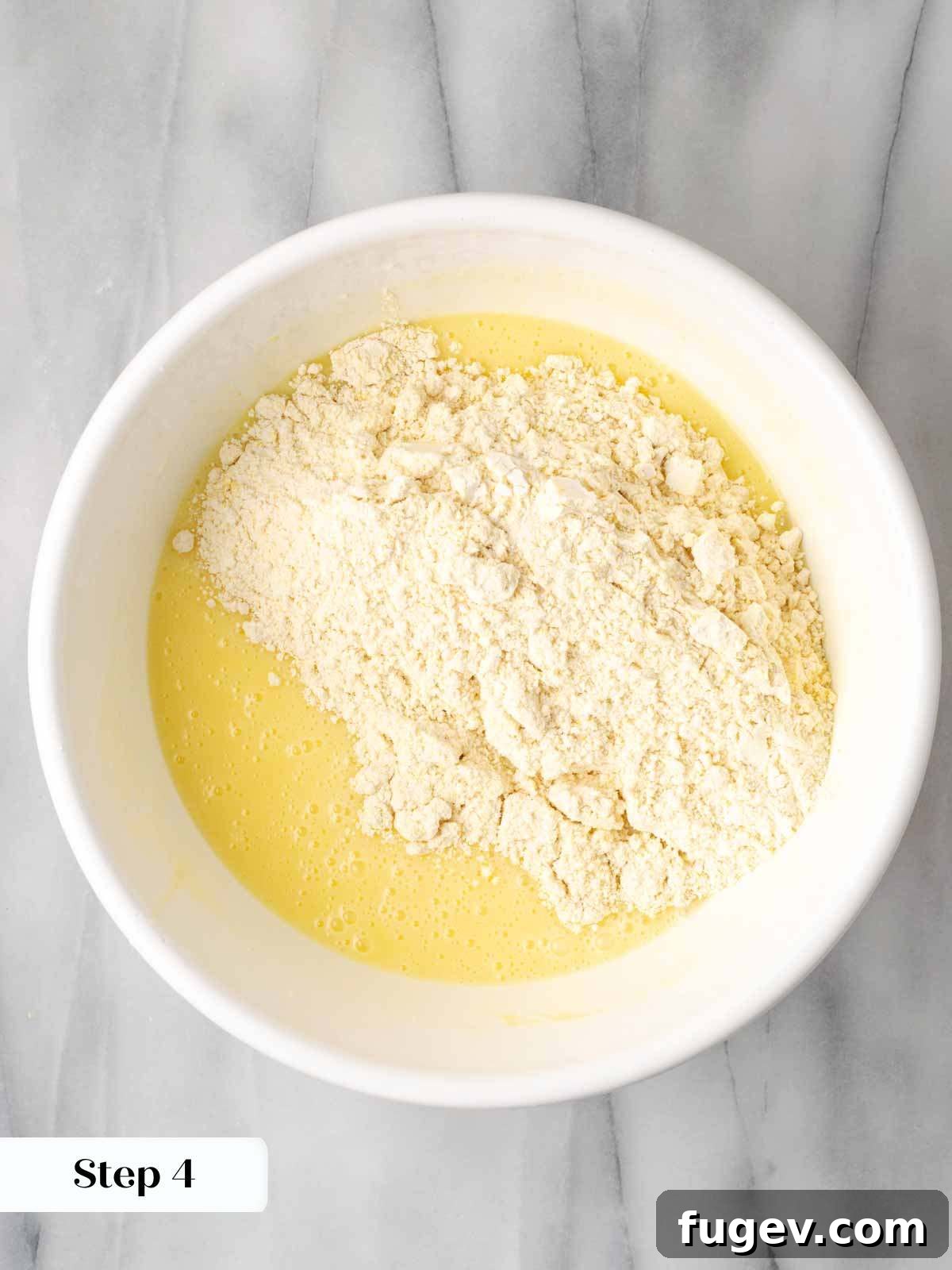 Sweet Cornbread Perfection 7 adding dry ingredients to cornbread batter.
