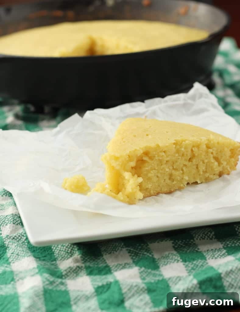 Sweet Cornbread Perfection 10 slice of cornbread baked in cast iron skillet on green towel.