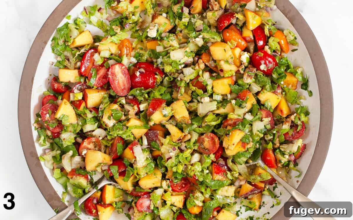 Sunshine Chopped Salad 5 The summer chopped salad beautifully tossed with balsamic vinaigrette, ready to be served in a large bowl.