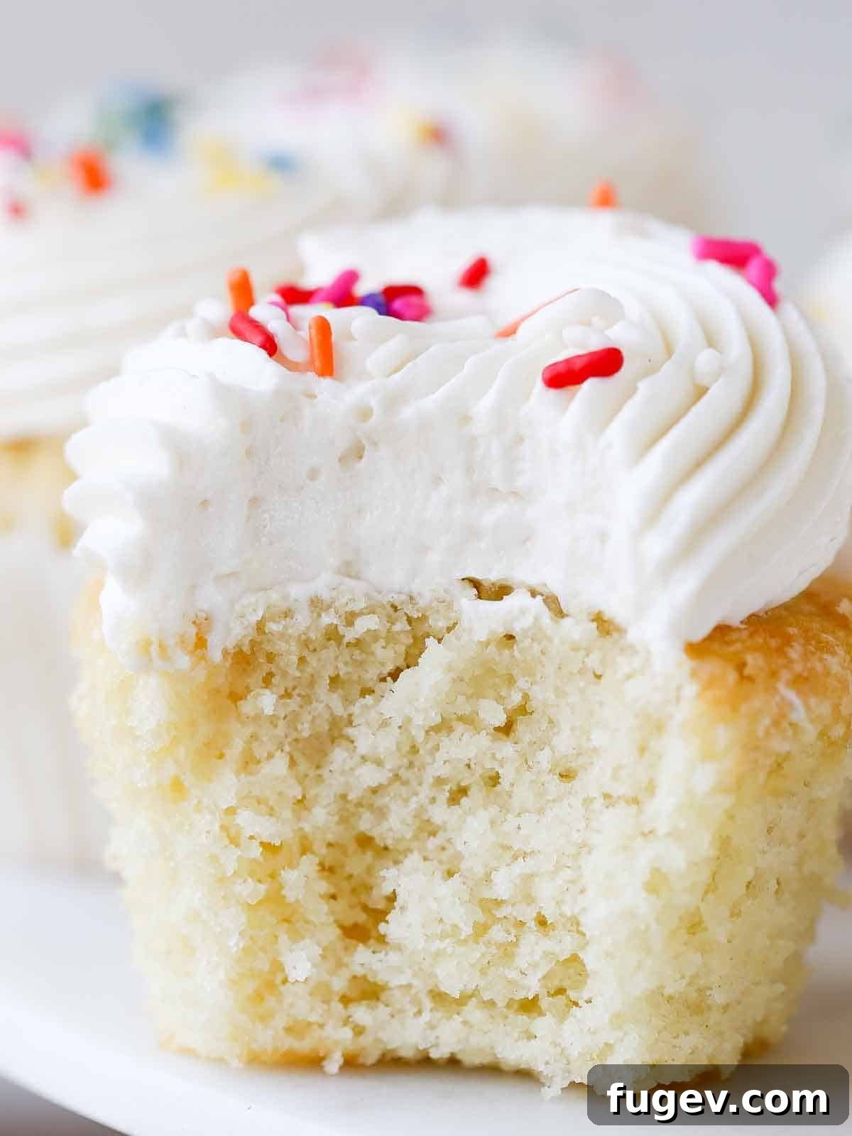 Golden Vanilla Bliss 2 Soft, moist vanilla cupcakes with fluffy ermine frosting and an inviting interior texture, ready to be enjoyed.