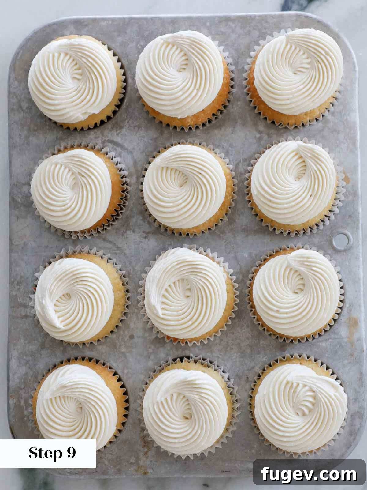 Golden Vanilla Bliss 11 Exquisitely frosted vanilla cupcakes with light ermine frosting, arranged beautifully in a vintage tin.