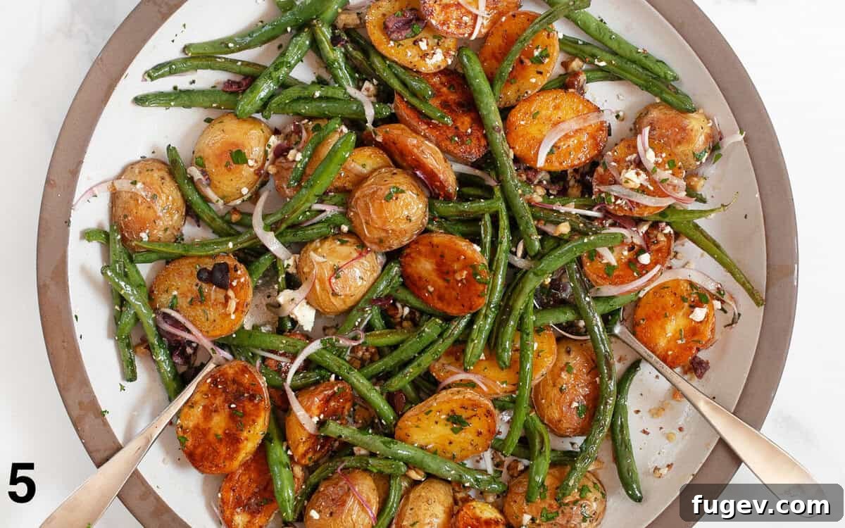 Rustic Roasted Potato and Green Bean Salad 6 A close-up shot of the roasted potato and green bean salad in a large mixing bowl, beautifully tossed with the lemon dressing and ready to serve.