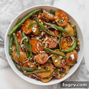 Roasted potato and green bean salad in a bowl.