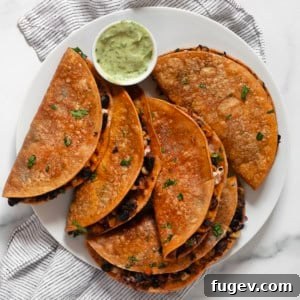 Crispy corn tacos on a plate.