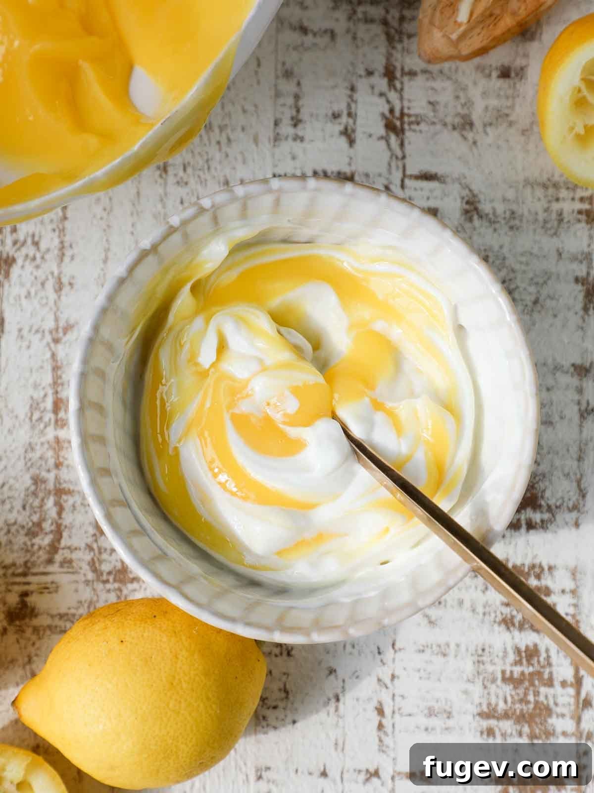 Sweet & Tangy Lemon Curd Inspirations 2 Smooth, vibrant yellow lemon curd on a rustic wooden background, hinting at fresh ingredients.