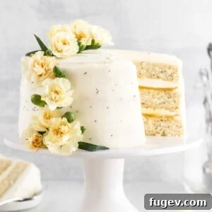 A three-layered lemon poppyseed cake, showcasing its delicate structure and frosting.