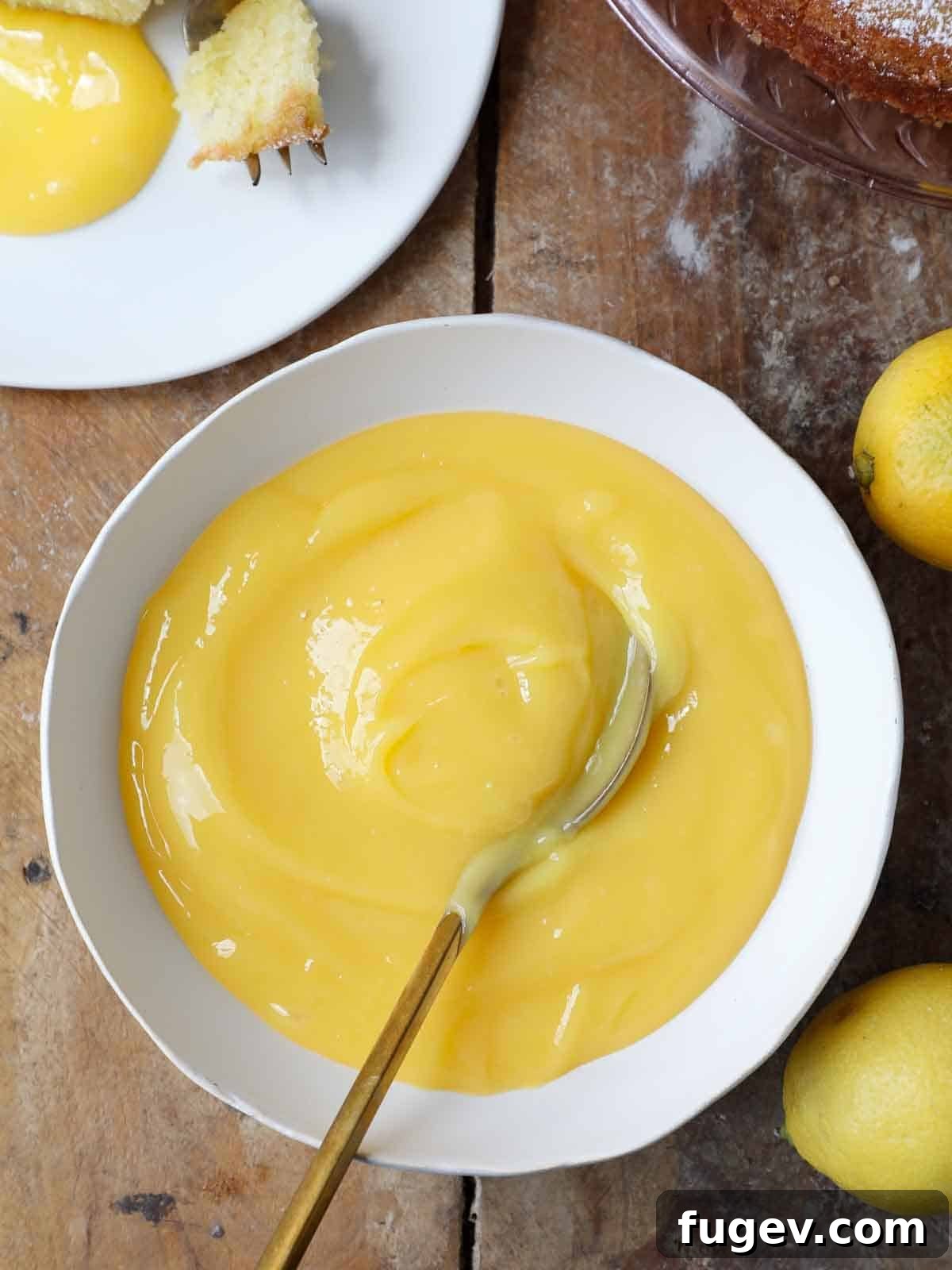 Sweet & Tangy Lemon Curd Inspirations 13 A pristine white bowl filled with luscious, vibrant lemon curd, ready for use.
