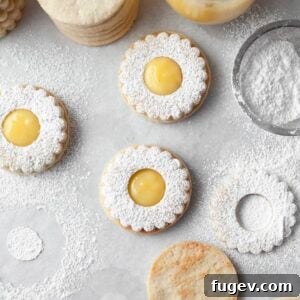 Lemon Linzer Cookies meticulously decorated as perfect circles, ready to be enjoyed.