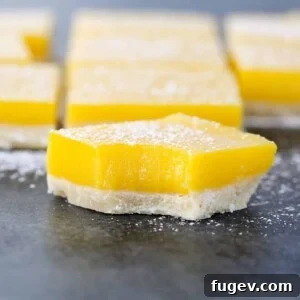Close-up details of amazing lemon bars, showcasing their perfect texture and powdered sugar dusting.