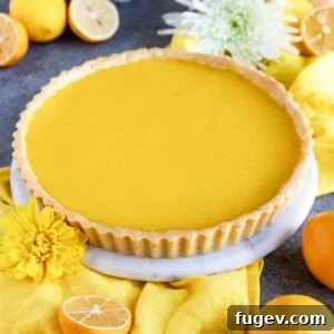 A stunning Meyer Lemon Tart, artfully presented with a yellow cloth napkin.