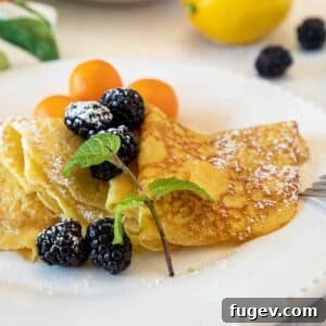 Lemon Curd Crepes garnished with fresh blackberries, ready for a delightful breakfast.