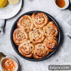Vegan lemon curd rolls beautifully plated with sauces on the side, showcasing their delightful appearance.