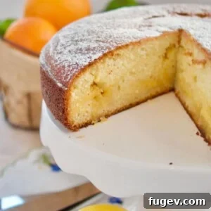 A delightful citrus curd cake with a slice already removed, showing the moist interior.
