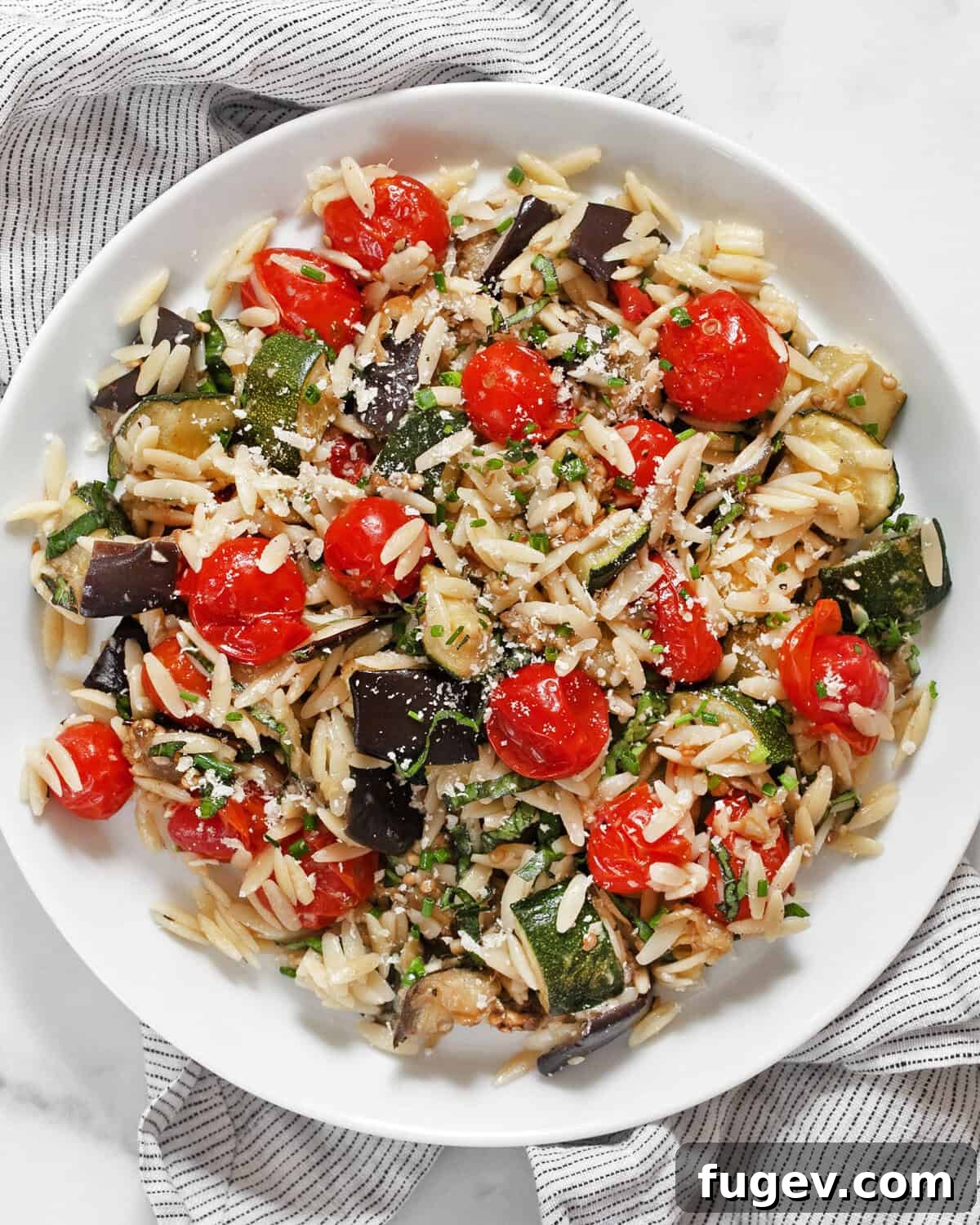 Roasted Mediterranean Vegetable Orzo 7 A close-up of the roasted eggplant, zucchini, and tomato orzo, showing its appealing texture and fresh herbs.