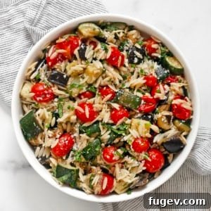Roasted Mediterranean Vegetable Orzo 8 Roasted eggplant, zucchini and tomato orzo in a bowl.