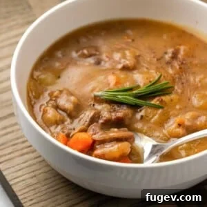 Hearty Lamb Stew 14 Hearty lamb stew on a spoon, ready to be enjoyed.