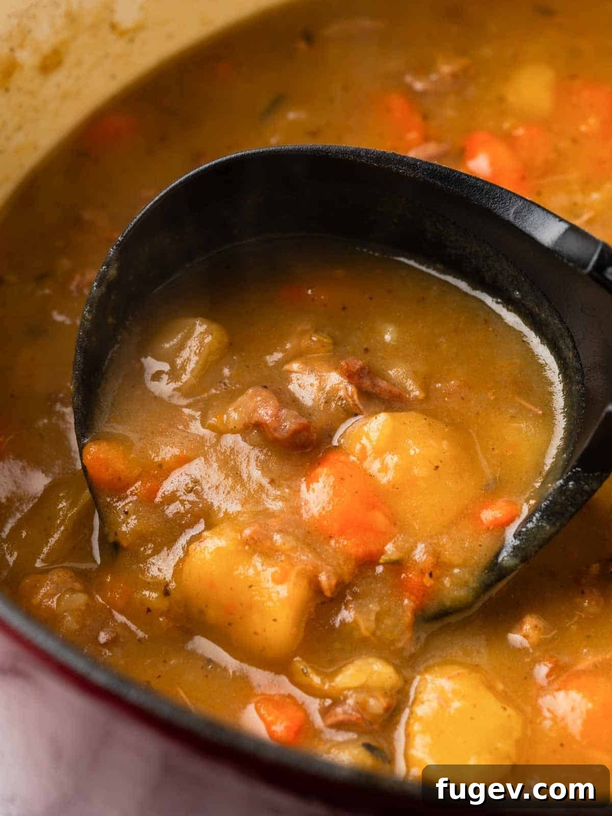 Hearty Lamb Stew 4 A ladle scooping a generous portion of rich, aromatic lamb stew, highlighting the tender meat and vegetables within the thick broth.