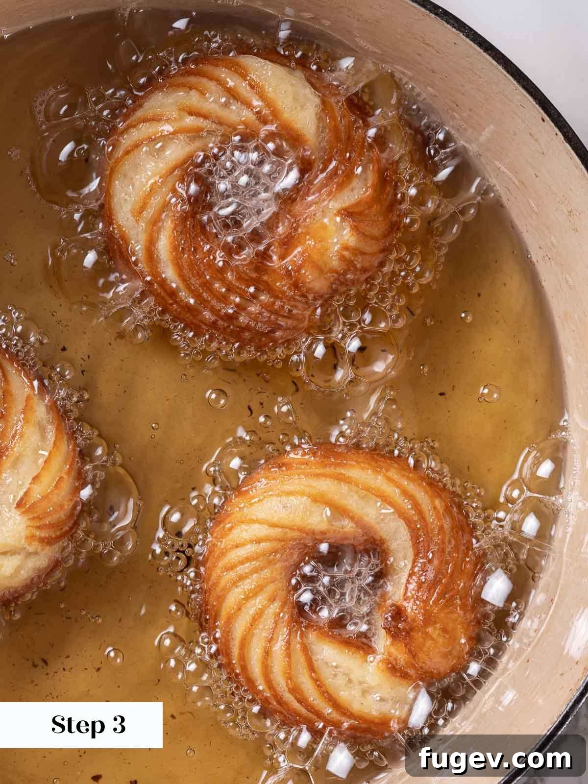 Elegant Choux Doughnuts 15 frying 3 crullers in oil with bubbles.