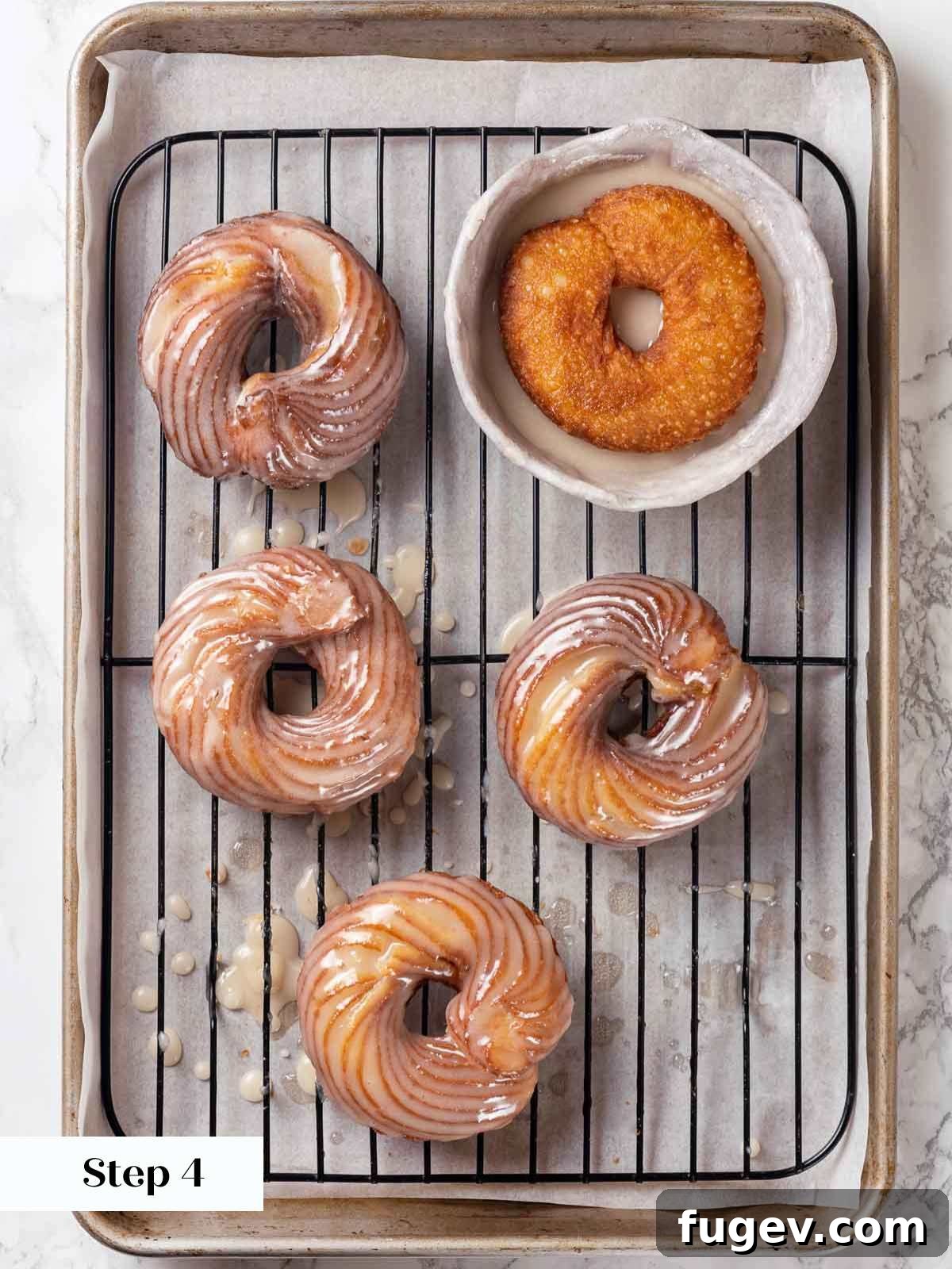 Elegant Choux Doughnuts 17 glazing crullers on wire rack.