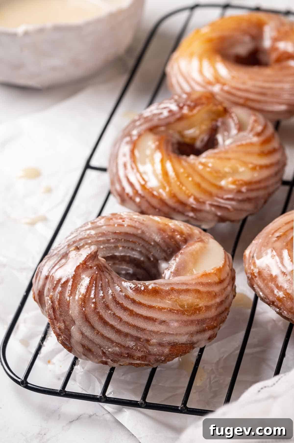 Elegant Choux Doughnuts 6 french crullers cooling on wire rack.