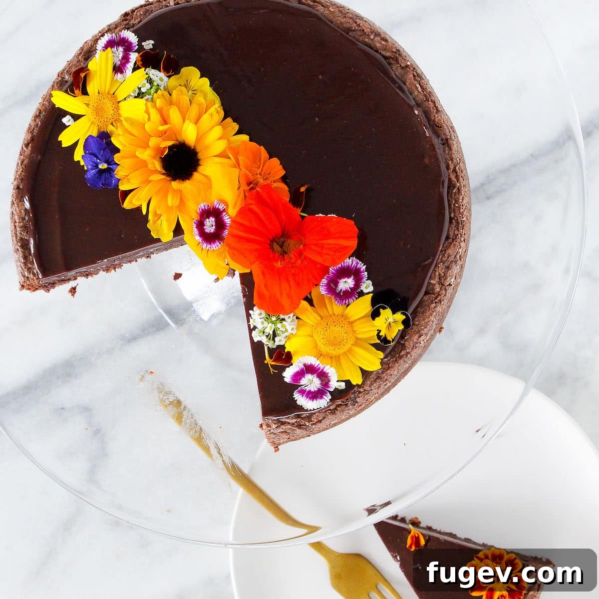 Mastering Chocolate Ganache 6 A slice of Hazelnut Flourless Chocolate Cake, beautifully topped with ganache and edible flowers.