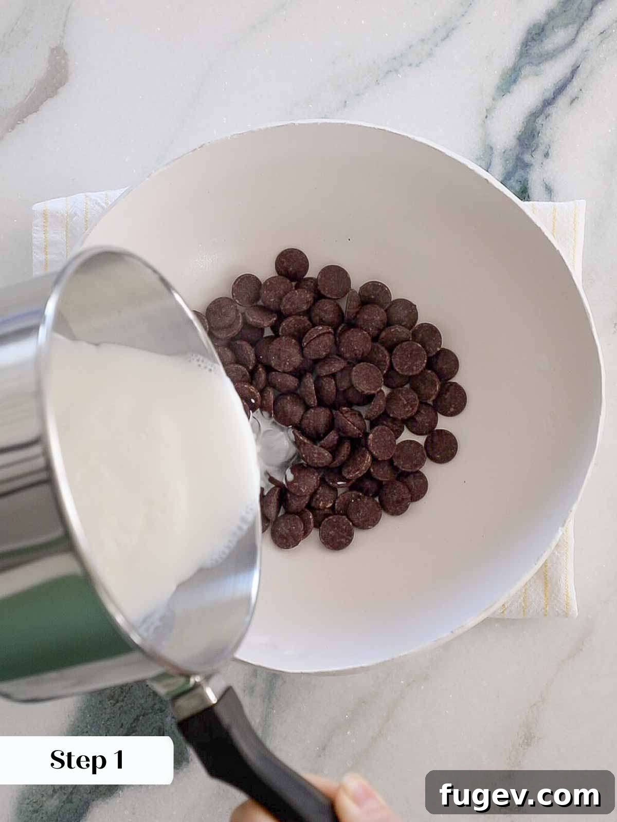 Mastering Chocolate Ganache 7 Chef pouring boiling cream directly onto chopped chocolate in a bowl.
