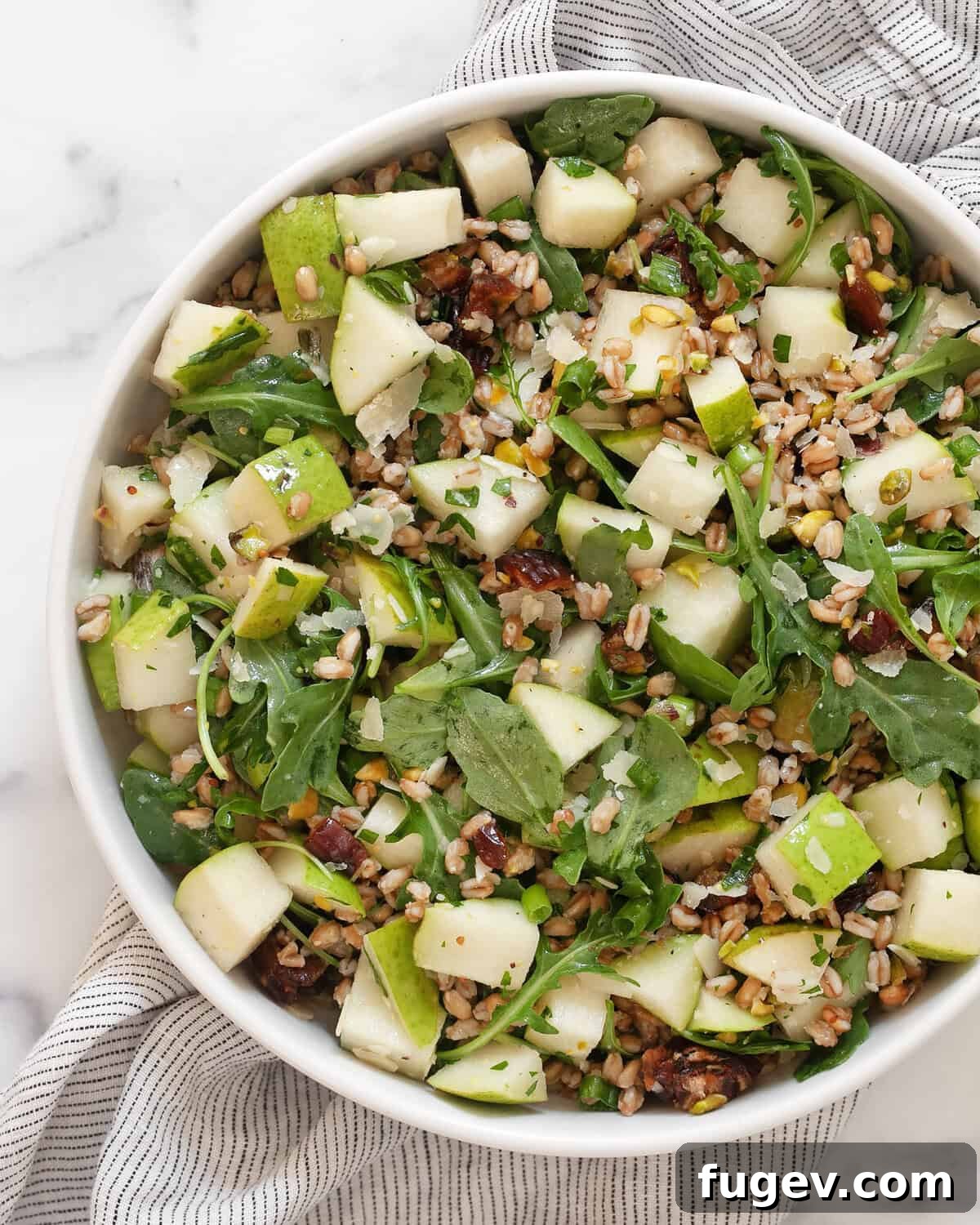 Sweet Pear and Hearty Farro Salad 2 A beautifully arranged pear farro salad in a rustic ceramic bowl, garnished with fresh herbs and a drizzle of vinaigrette.