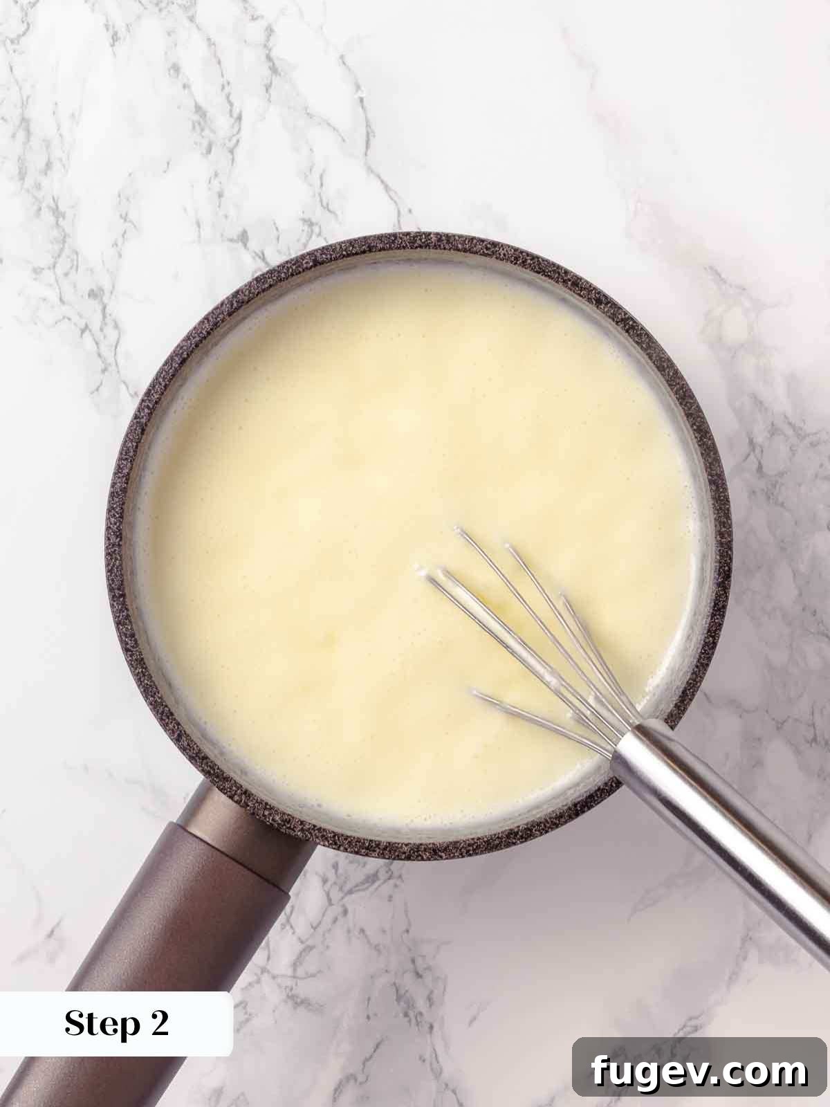 Zesty Lemon Cream 6 Heavy cream and sugar mixture boiling gently in a saucepan, showing a slight reduction in volume as it thickens over the heat.