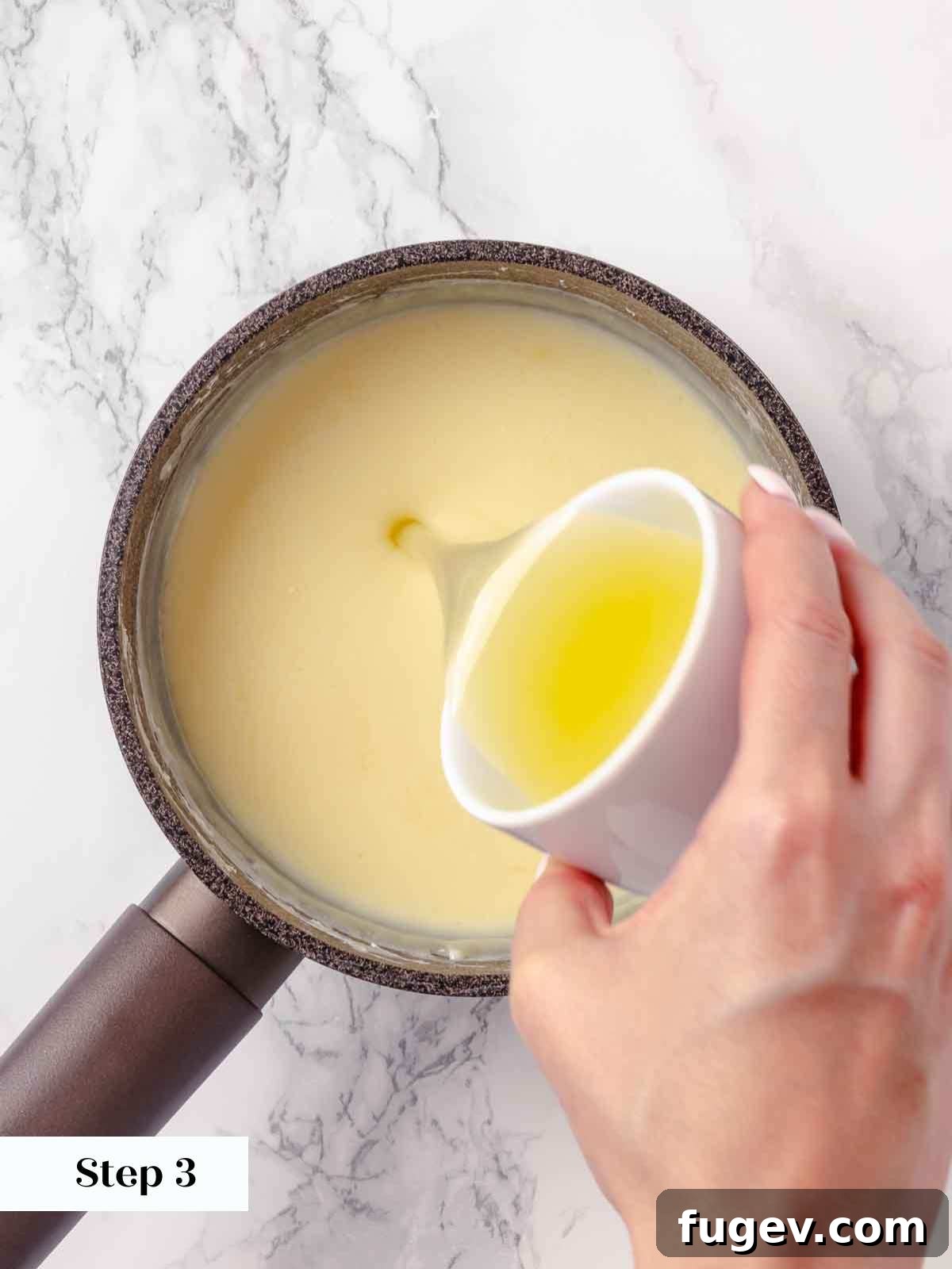 Zesty Lemon Cream 7 Freshly squeezed lemon juice being poured into the boiled and thickened cream mixture in a saucepan, immediately after being removed from the heat.