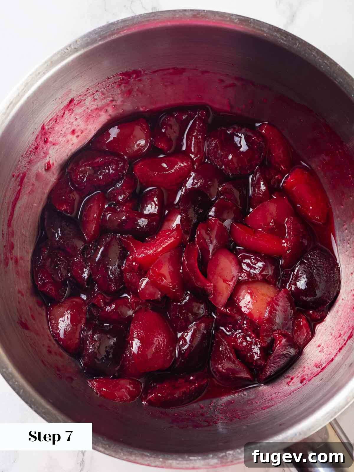 Zesty Lemon Cream 10 Fresh cherries, sugar, and lemon juice simmering in a small saucepan on a stove, illustrating the preparation of the easy cherry sauce.