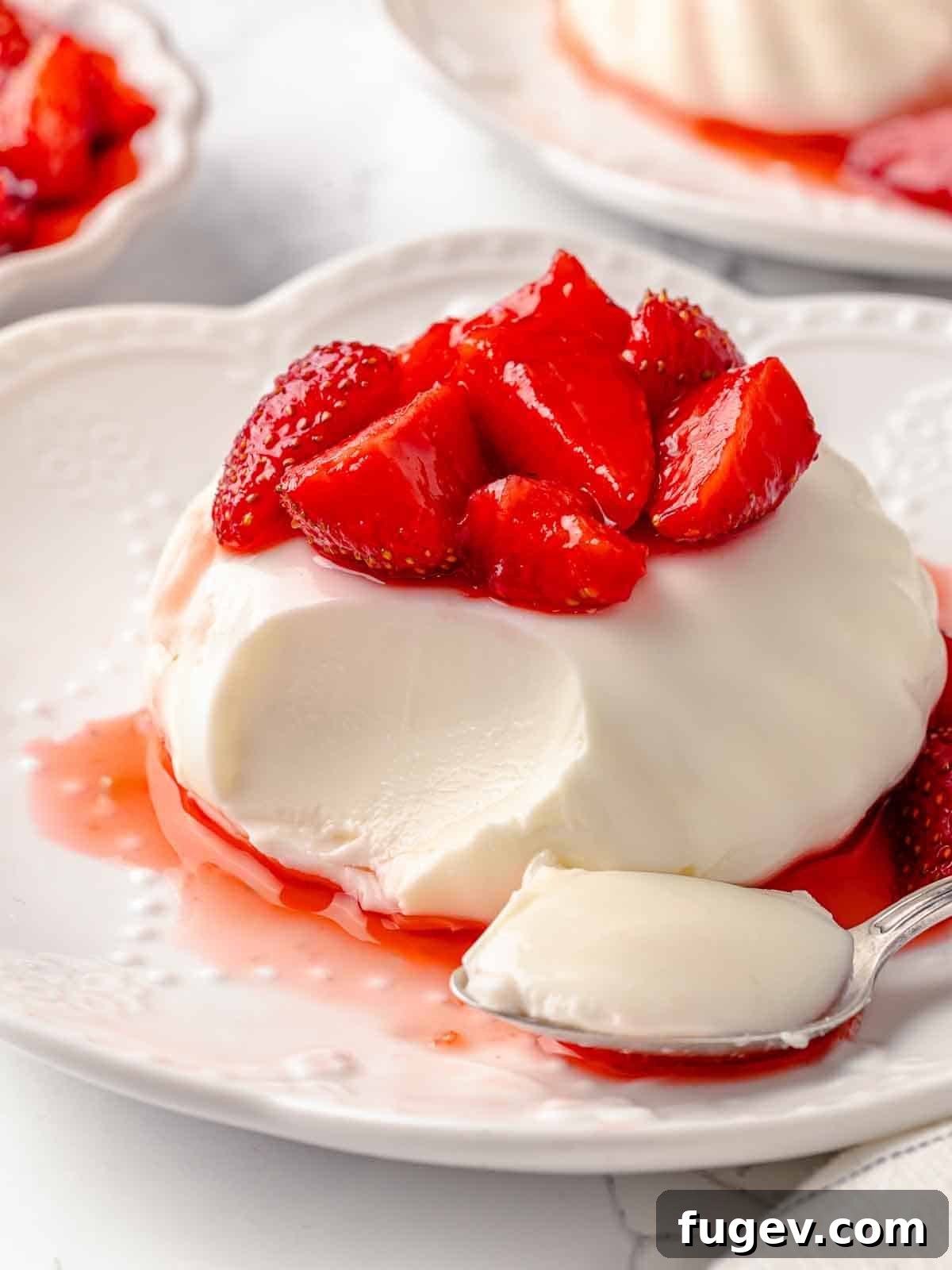 Tangy Buttermilk Panna Cotta 2 buttermilk panna cotta with bite on spoon.