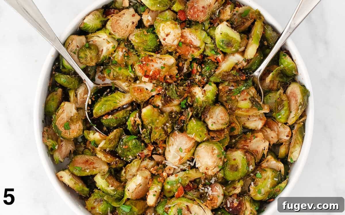 Caramelized Balsamic Sprouts 6 Roasted brussels sprouts being stirred with toasted almond breadcrumbs, Parmesan cheese, and fresh herbs in a bowl.