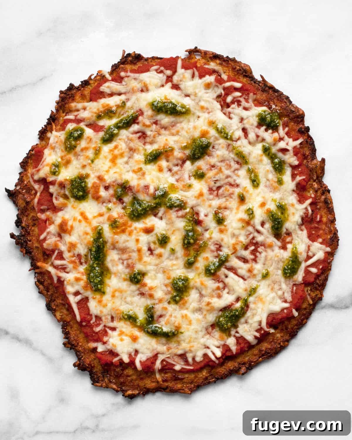 Power Cauliflower Crust 2 Delicious cauliflower crust pizza drizzled with fresh pesto, ready to be served.
