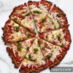 Sliced cauliflower pizza crust on a wooden board.