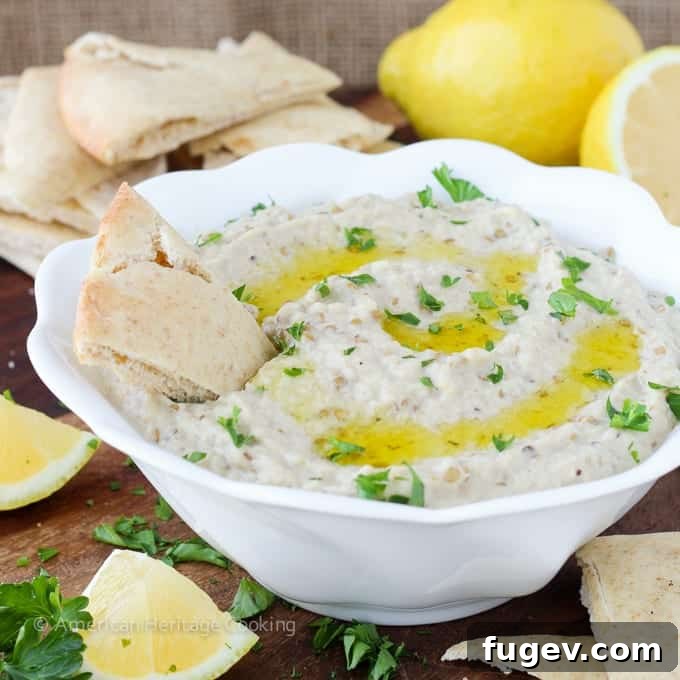 Smoky Eggplant Dip 2 Close-up of a bowl of creamy, smoky Baba Ganoush garnished with fresh parsley and a drizzle of olive oil, ready to be scooped.