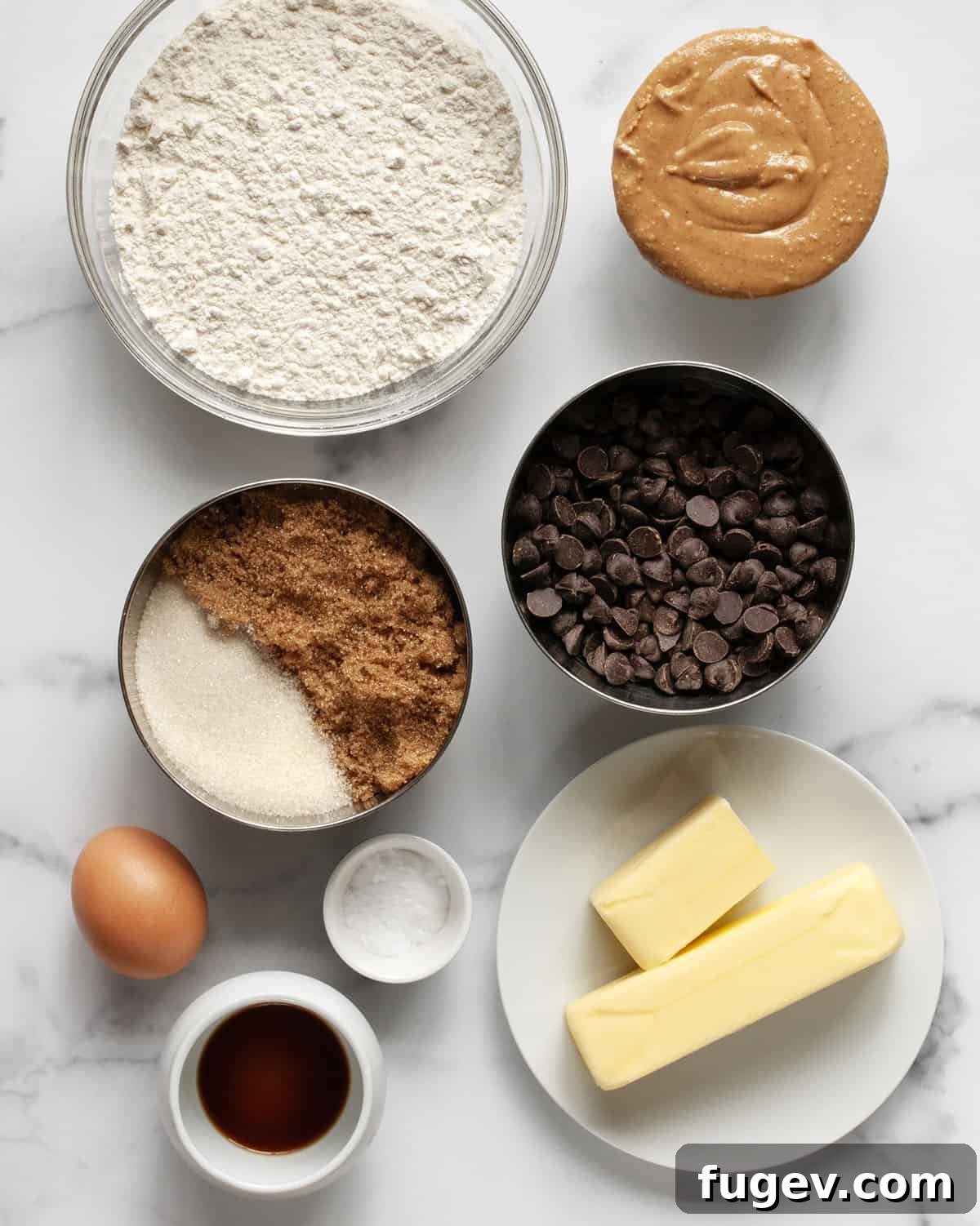 Chewy Chocolate Chip Peanut Butter Cookies 3 A curated display of all ten ingredients for chocolate chip peanut butter cookies, including flour, peanut butter, sugars, chocolate chips, butter, egg, salt, baking soda, and vanilla extract, ready for baking.