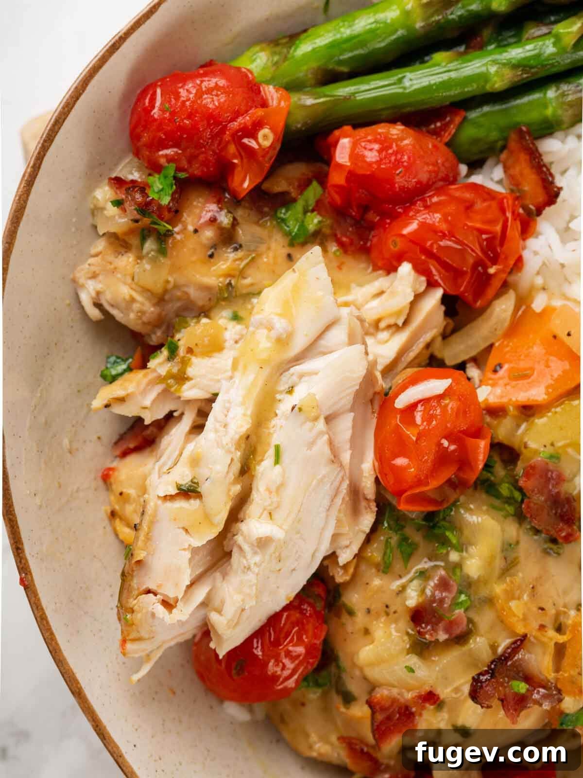 Bright White Wine Chicken 12 Served chicken in white wine sauce on a white plate, accompanied by fresh asparagus spears.
