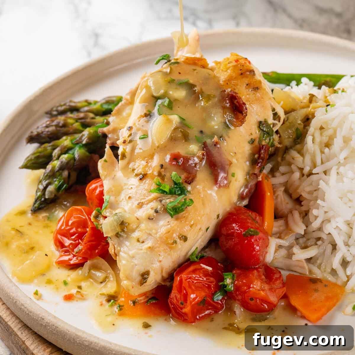 Bright White Wine Chicken 3 Cooked chicken in white wine sauce served in a skillet on a white marble countertop, garnished with fresh herbs and tomatoes.