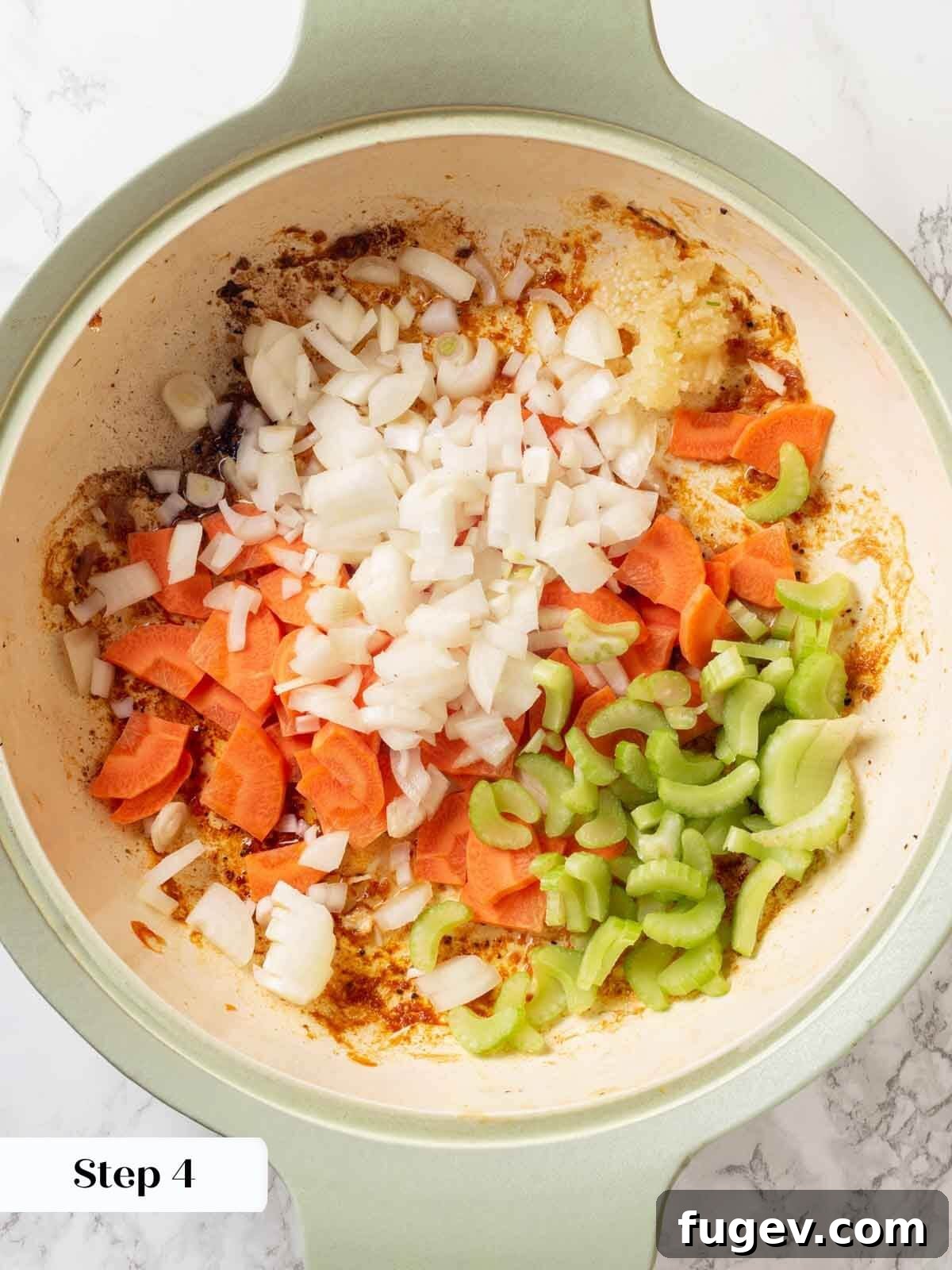 Bright White Wine Chicken 7 Chopped onions, carrots, and celery in a skillet, gently cooking before adding other liquids.