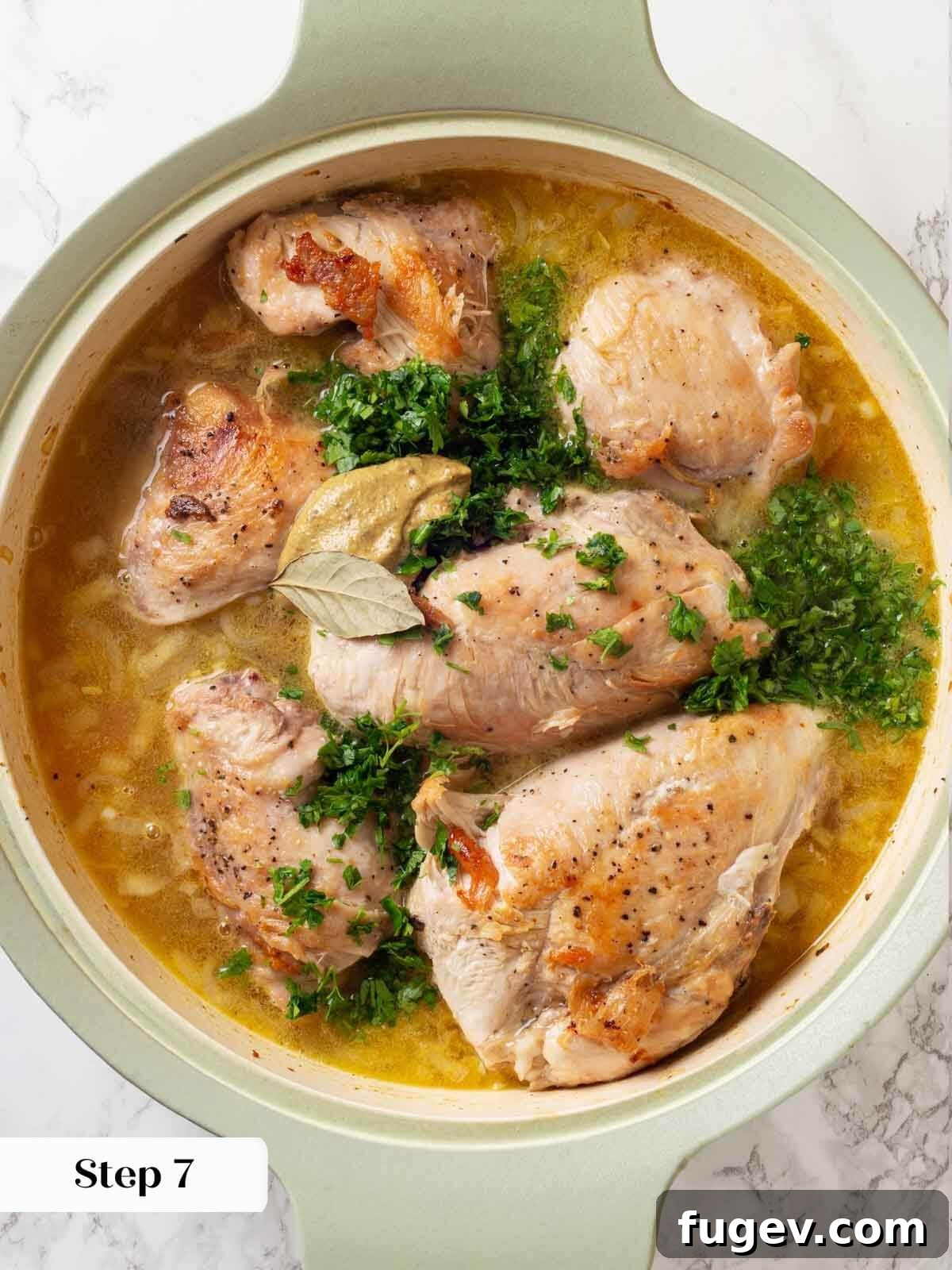 Bright White Wine Chicken 8 The chicken and sauce in the skillet with a bay leaf, ready for baking in the oven.