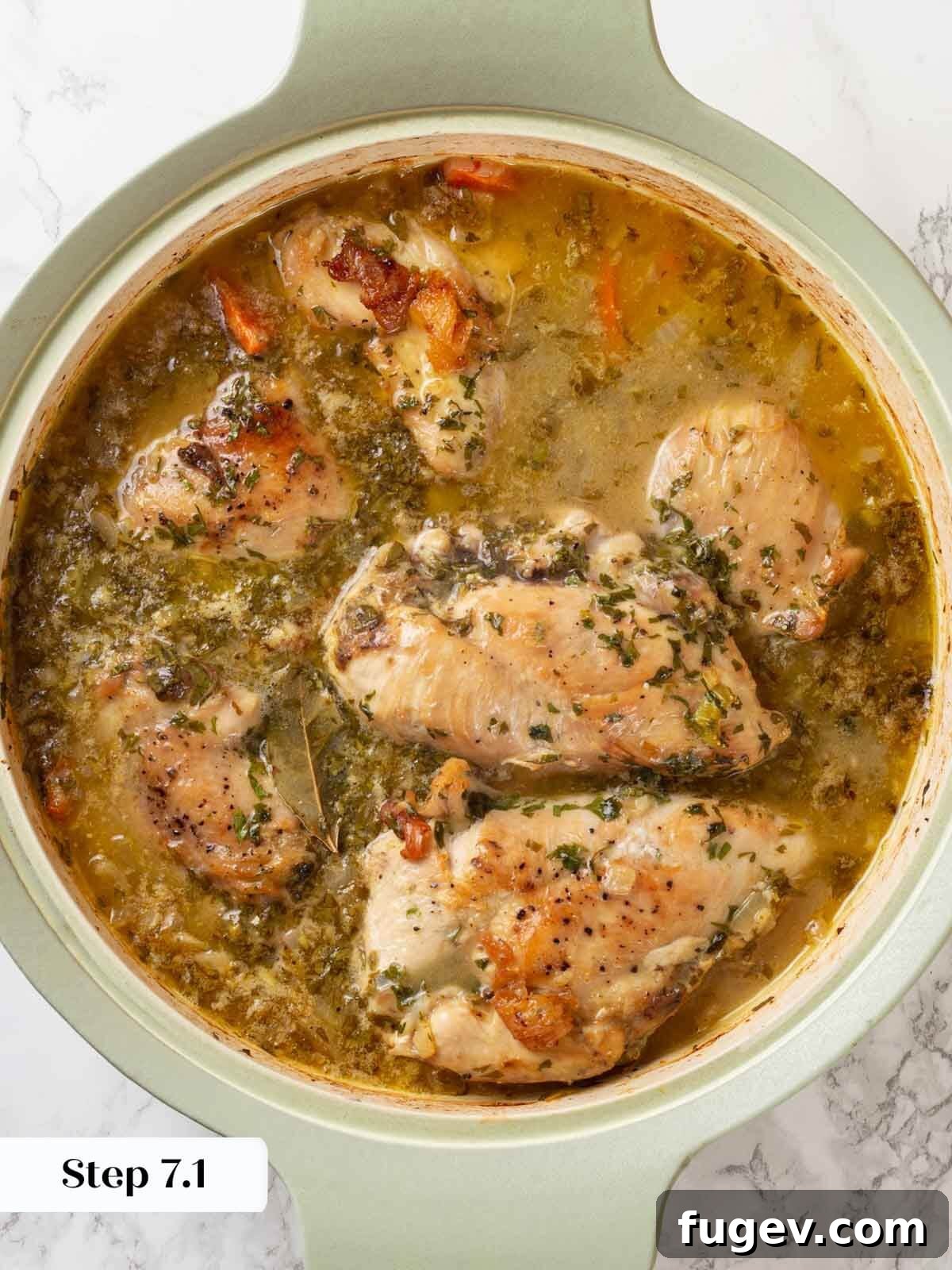 Bright White Wine Chicken 9 The chicken in wine sauce, bubbling gently in the skillet after baking, looking tender and cooked through.