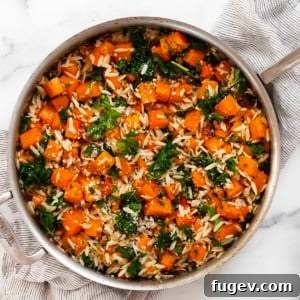 Roasted butternut squash kale orzo in a pan.