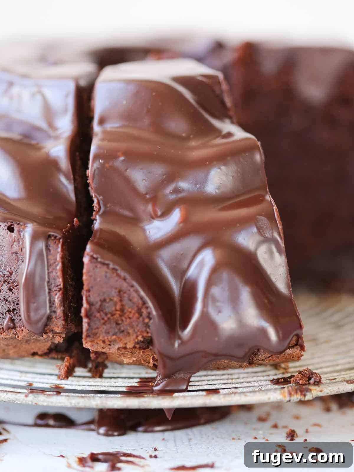 Decadent Chocolate Bundt 10 A rear view of a slice of chocolate bundt cake, fully coated in a smooth chocolate ganache, showcasing its rich texture.